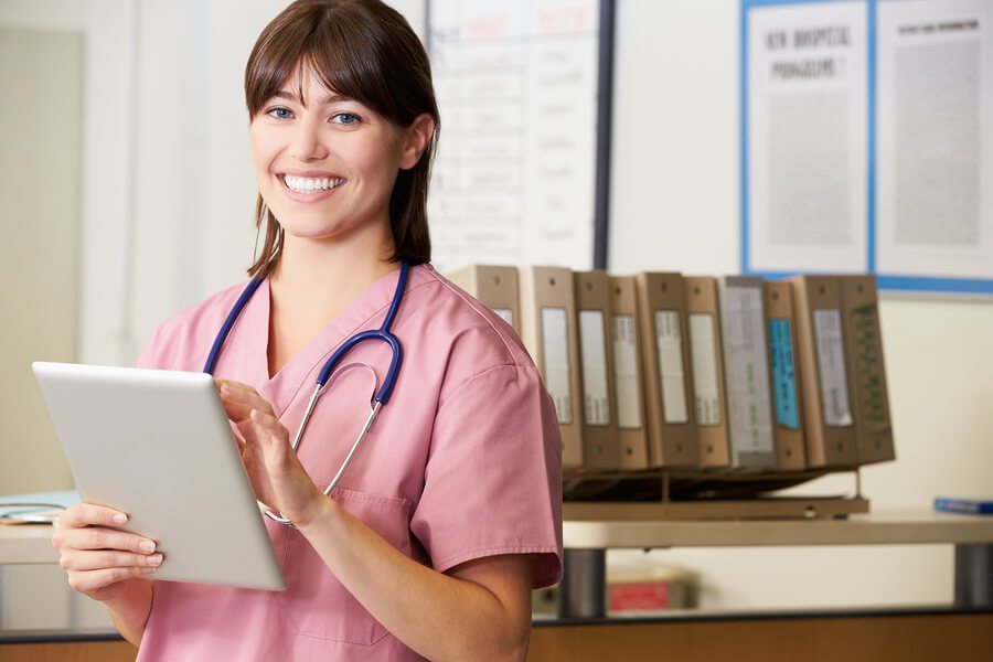 Nurse Using Digital Tablet At Nurses Station