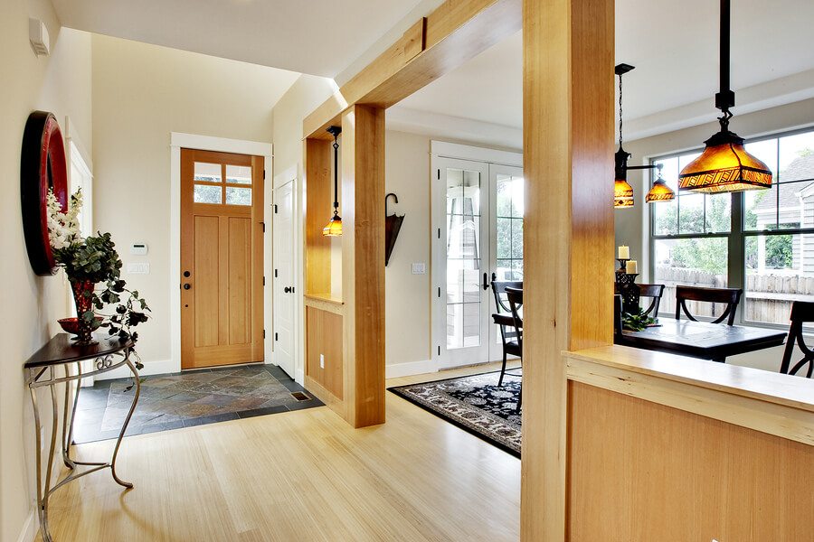 Wide view of home entrance and hallway with dining room in view
